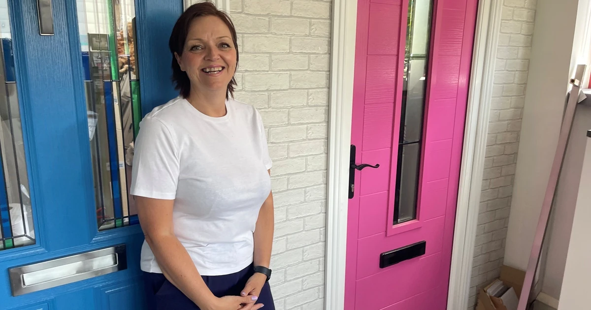 Jodie Jefferson, director, Didcot Windows standing in front of an Apeer door
