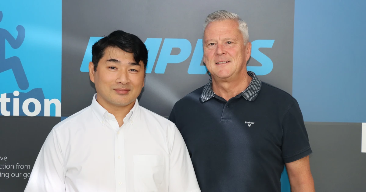 Two men standing side by side against an Emplas branded wall