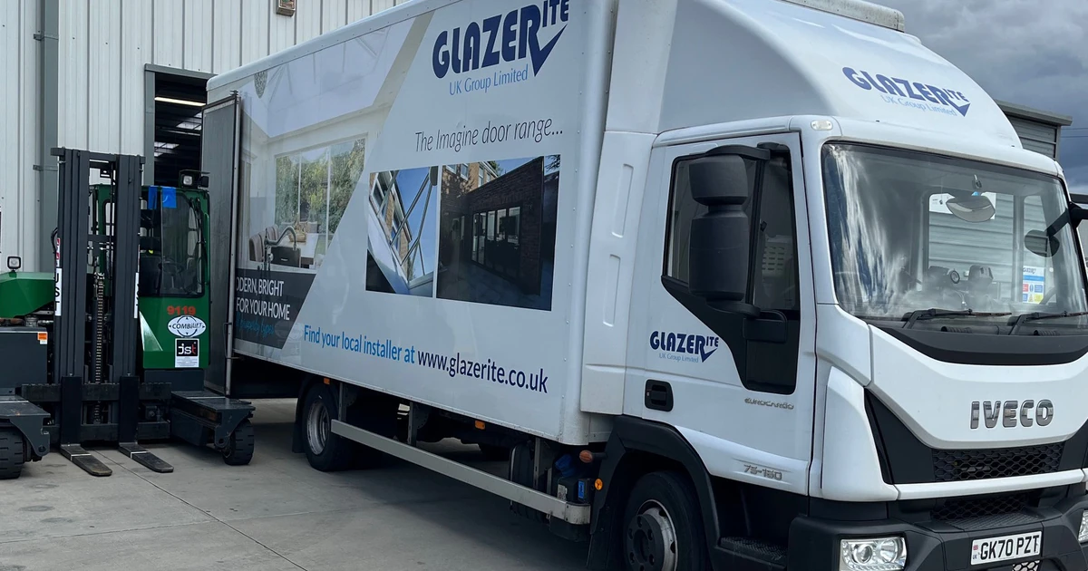 White Glazerite-branded Iveco delivery truck parked outside a warehouse under a cloudy sky